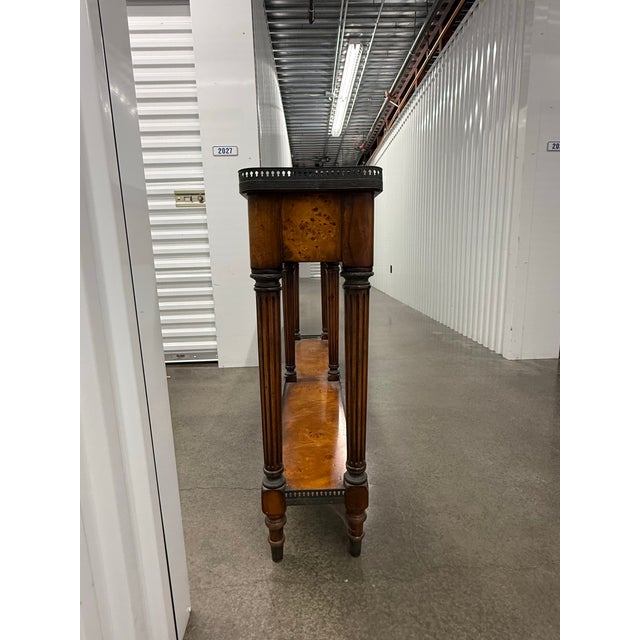 A solid wood console table, decorated throughout with verdigris brass mounts, the galleried top above four frieze drawers...
