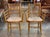 A pair of 19th century painted faux bamboo armchairs, the frames ring-turned in imitation of bamboo on an ochre ground...
