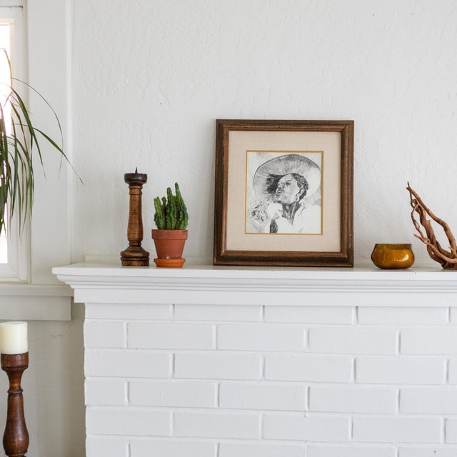 An early 20th-century pen and ink portrait of a man in profile, smoking a cigarette while wearing a wide-brimmed hat. This...