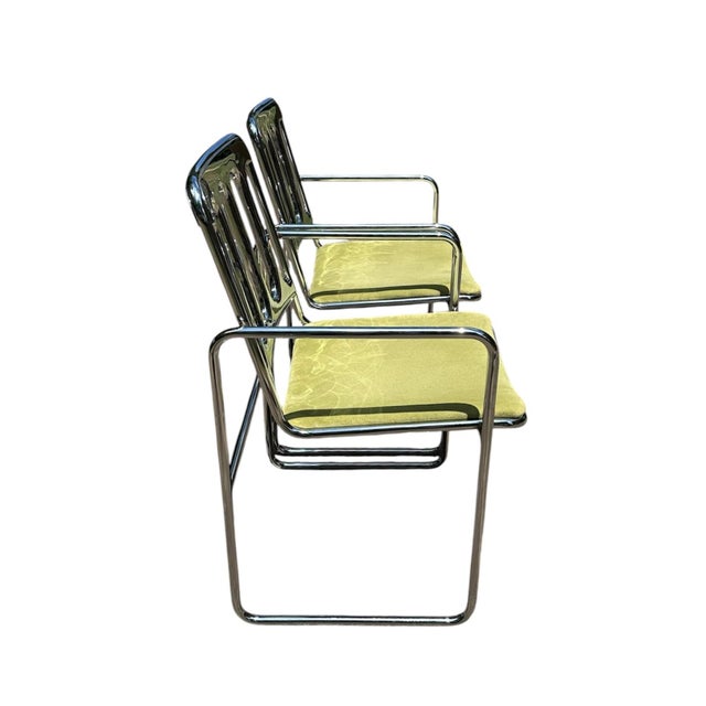 A gorgeous set of mid century chrome armchairs. Each features a cantilevered, tubular chrome frame armchair with a...