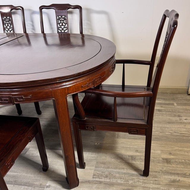 Impressive Chinese influence "longevity" extending dining table with two armchairs and 8 side chairs. Almost 95% of...