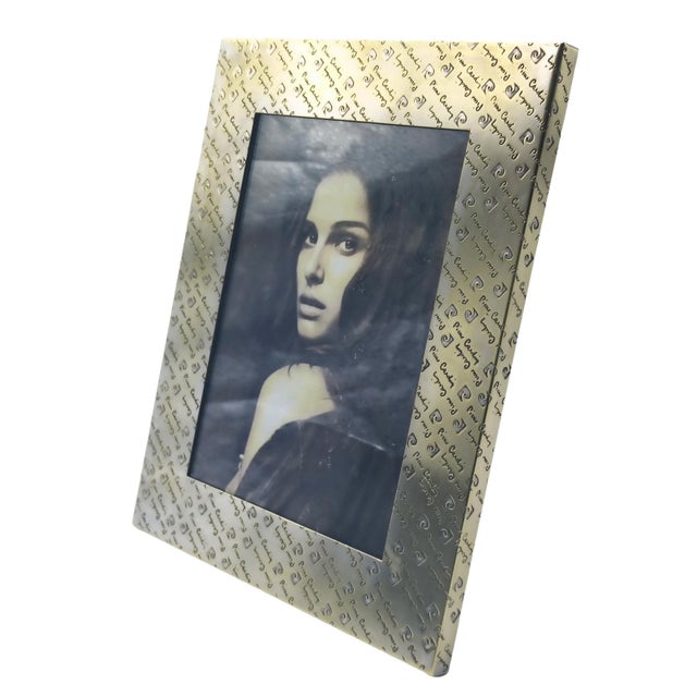 Rectangular brass tabletop photo frame with Pierre Cardin signature engraved across the frame. This piece has an...