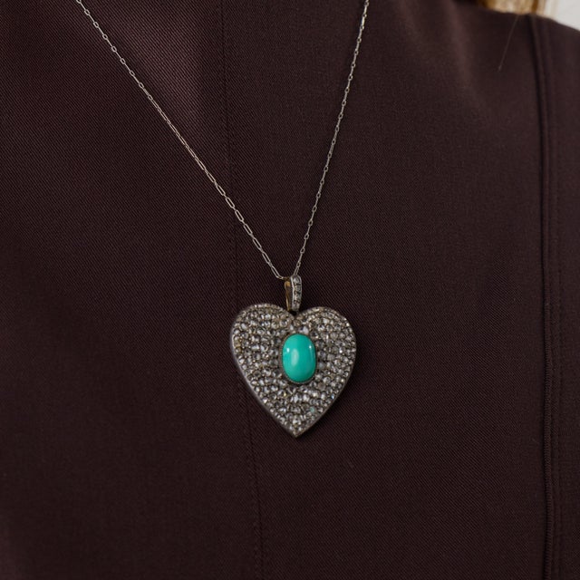This extraordinary Victorian heart pendant necklace is a richly detailed jewel from the 1880’s, centered by an oval cut...