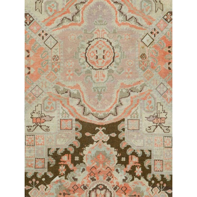 An antique Russian Karabagh rug from the first quarter of the 20th century featuring tones of coral, browns and light...