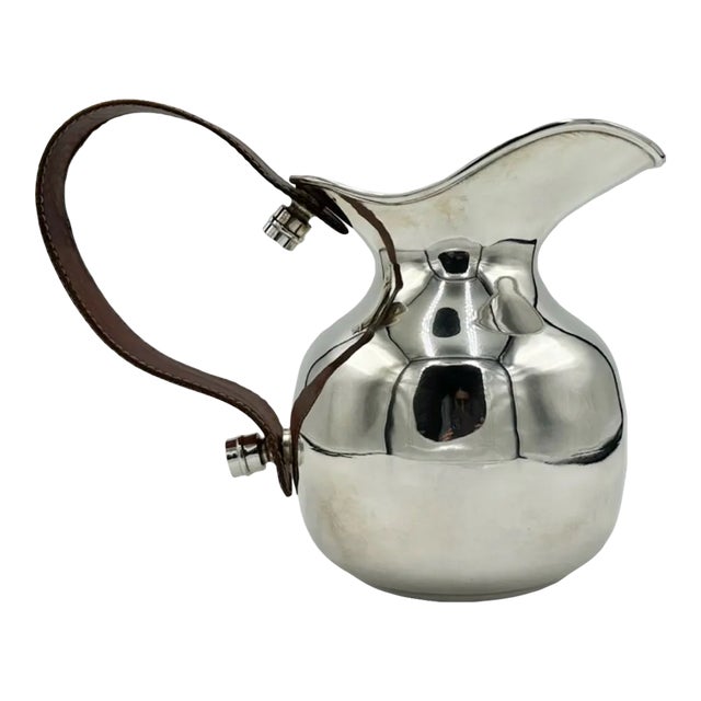 Details: -Vintage Hermès Paris silver-plated pitcher with rich brown leather handle -This elegant piece showcases Hermès'...