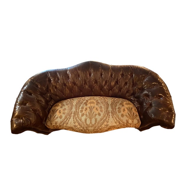Victorian revival curved sofa by Paul Robert Inc., featuring a deep diamond-tufted dark brown leather backrest, rolled...