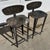 1980's sturdy hammered artisan made steel bar stools with abstract cutout detailing. Comfortable low backs and foot rests...