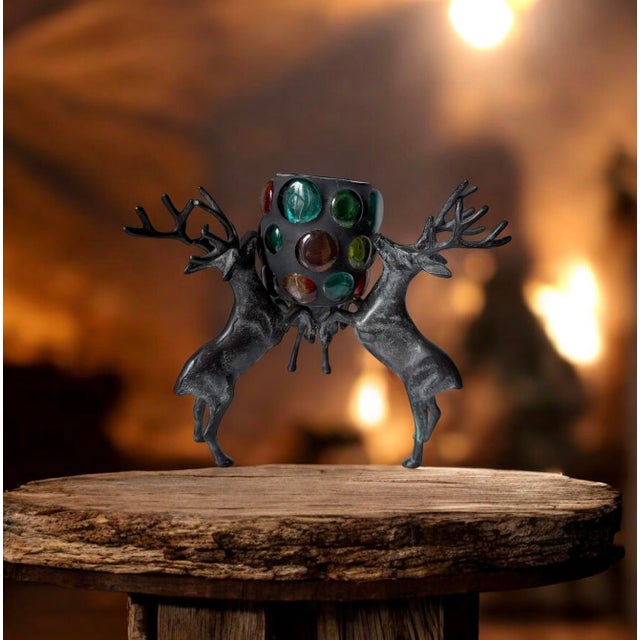 cast iron reindeer candle holder with a multi-colored glass pillaR. Christmas, holidays decor.