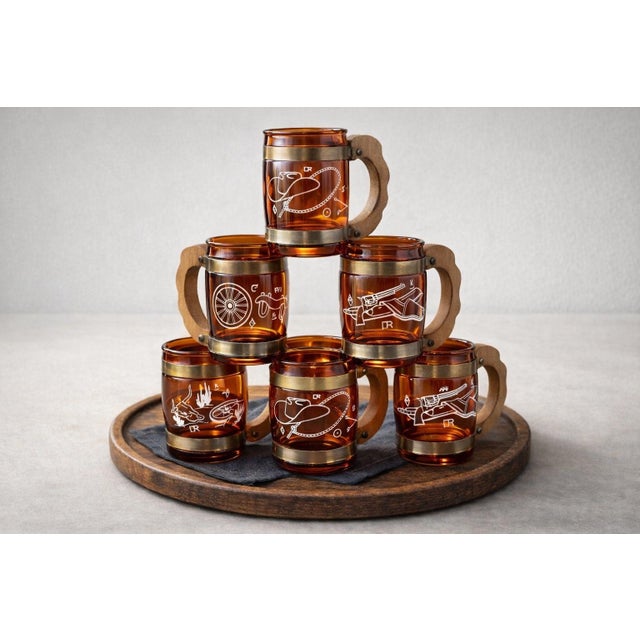 Striking set of six mid-century amber glass bar mugs featuring iconic Western motifs. Each mug is fitted with sculptural...