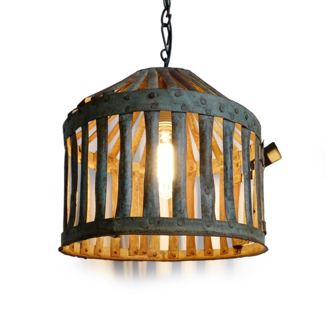 Vintage Indian iron cage basket thoughtfully repurposed into a one-of-a-kind pendant light, celebrating the raw beauty of...