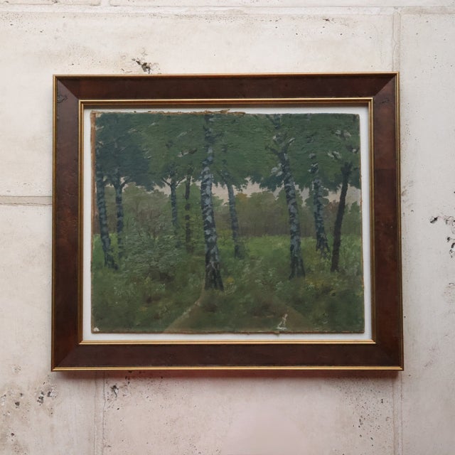 20th Century French Tree Line Painting depicts a quiet woodland scene with a row of slender trees rising through a deep...