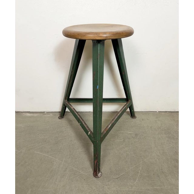 Vintage Industrial factory stool made in former Czechoslovakia during the 1960s It features a wooden seat and a green iron...