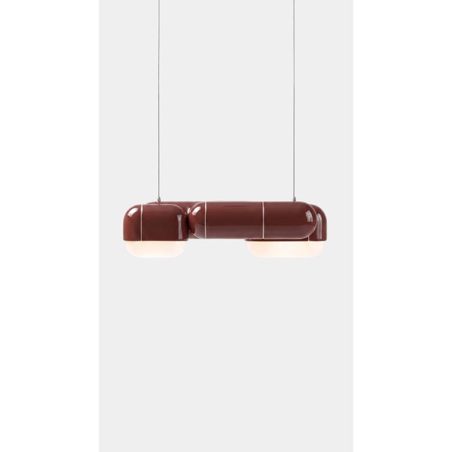 A pendant that changes with the day. In daylight its printed shell reads crisp and architectural, all shadow and ridge;...