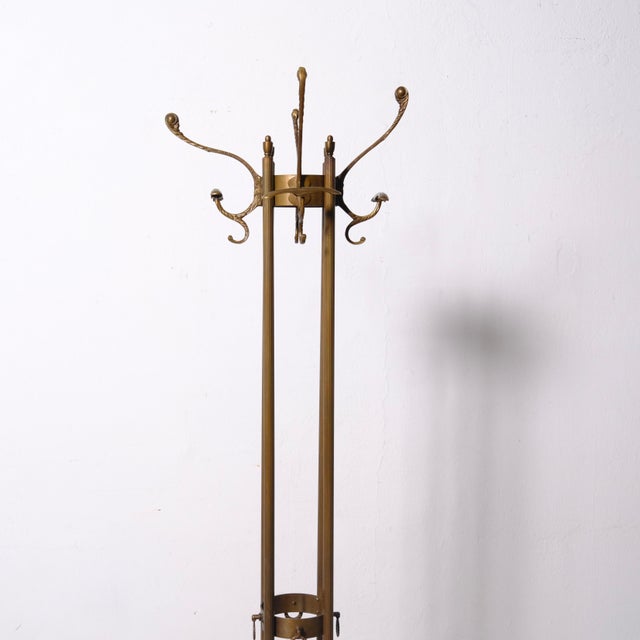 Beautiful metal alloy coat hanger, Hollywood Regency style. Height: 170 cm Base diameter: 41 cm Stem diameter: 12 cm
