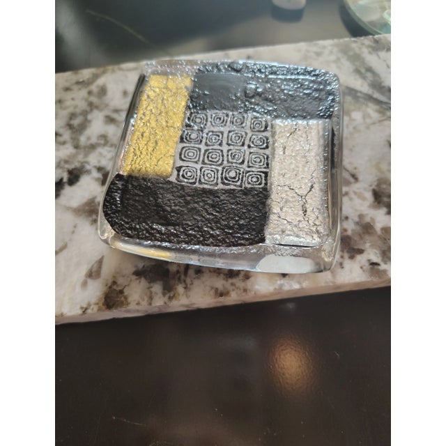 this classic Murano glass paperweight is 3.5" by 3.5" by 1," it contains real gold and silver laid out in an orginized...