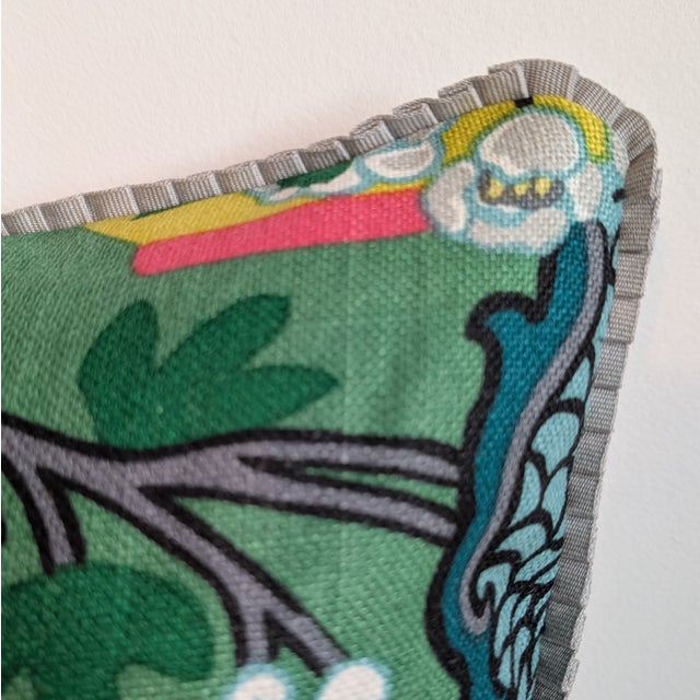 Schumacher Chiang Mai Dragon pillow in emerald, with mini gray ruffled trim and striped pink and green back. Invisible...