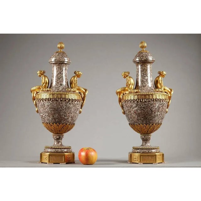 Pair of ural granite and gilt bronze ornamental vases in louis xvi style. Young women in gilt bronze sit on the shoulders...