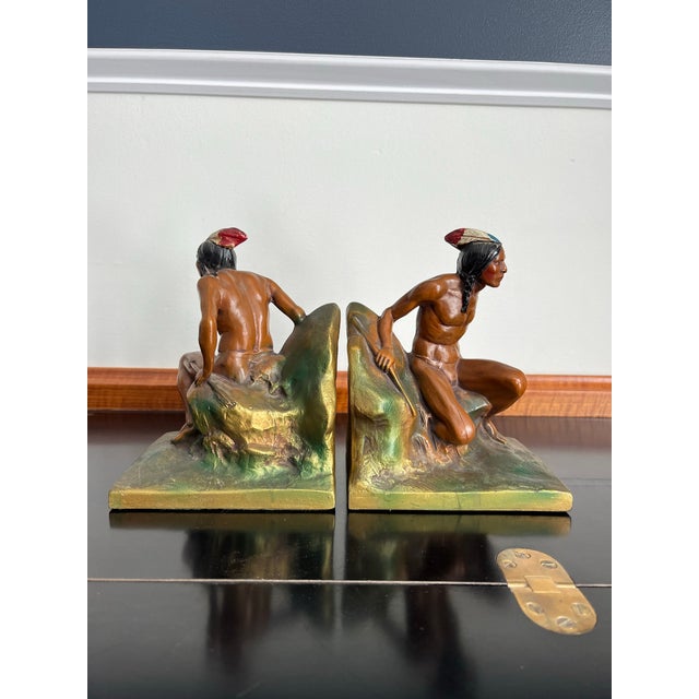 Striking pair of early 20th-century Native American Indian figural bookends, beautifully modeled and hand-painted in rich...