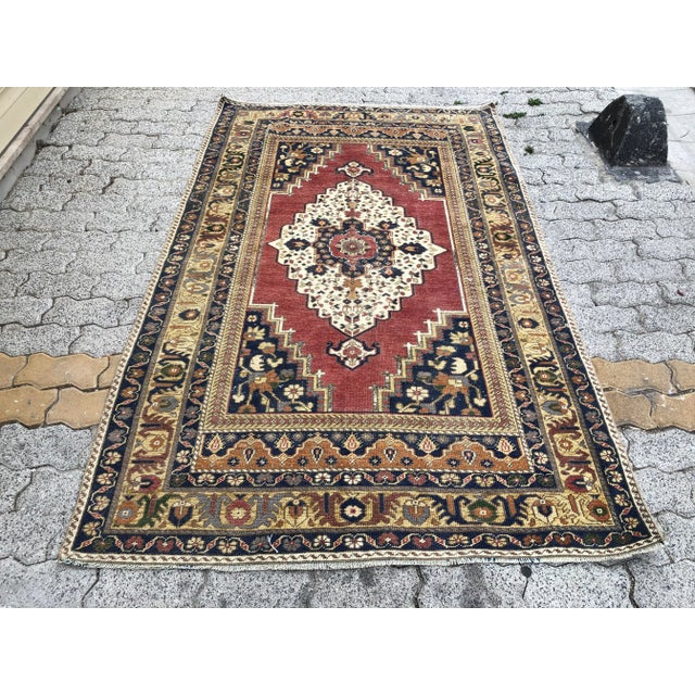 This is a vintage Turkish Oushak rug from the 1960s. The piece was hand-knotted.