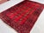 A vintage Afghan Ersari Turkmen rug in the classic Bokhara design — three columns of small quartered güls float on an...