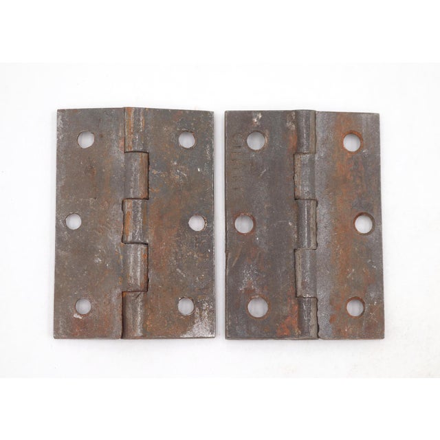 Vintage cabinet hinges made of cast iron with flat tips, five knuckles, and a template hole pattern. The original mounting...