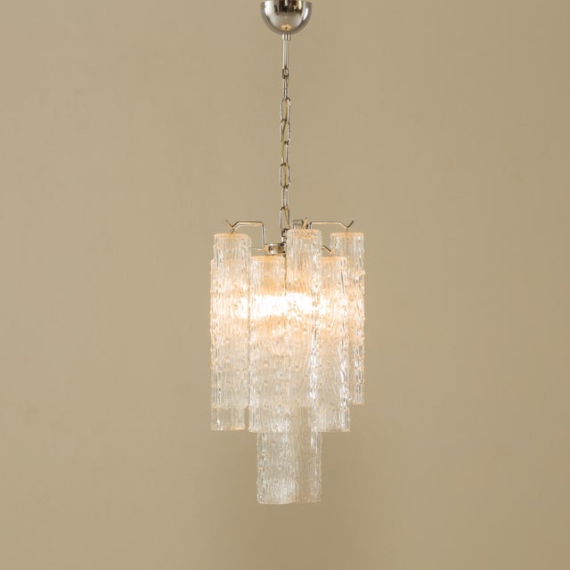 This vintage chandelier, based on the glasswork, was designed by Toni Zucceri and made in the 1970s by Venini. The Murano...