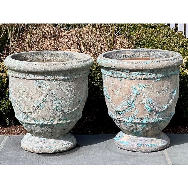 A striking pair of French Anduze-form planters, crafted in terracotta and finished with a richly textured glaze. The...