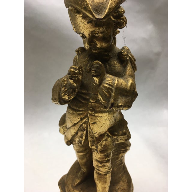 Very sweet ceramic figurine of 18th Century boy wearing tricorn hat. This interesting piece is actually a bud vase to hold...