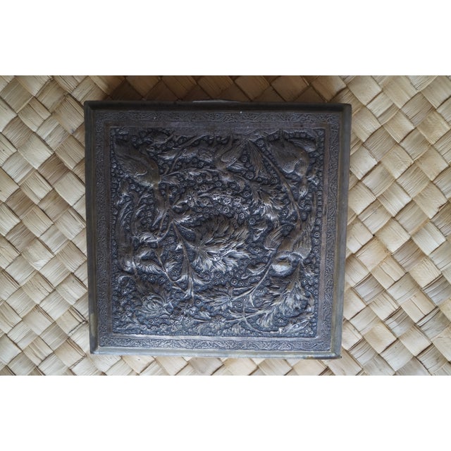 A silver repousse box which is decorated with birds and flora. This box is quite beautiful and it has not been polished,...