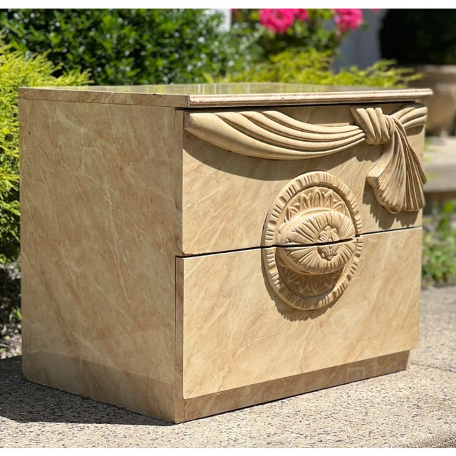 Elegant Mid Century Italian nightstand with faux marble laminate. Made in Italy. This unique stand features a graceful,...