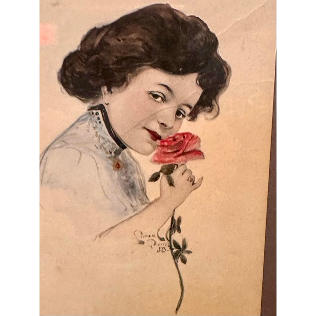 Antique watercolor portrait of a woman with flowers, signed by the artist. The painting is done on paper and framed in a...