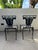 Elegant and architectural pair of vintage cast iron garden chairs featuring beautifully detailed lyre-form backs adorned...