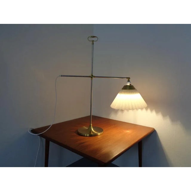 This is an adjustable table lamp from Le Klint from the 1960s. The model is Model 319. Under the stand is the maker's...
