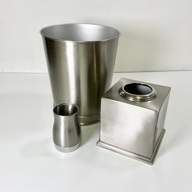 This contemporary bathroom accessory set includes a wastebasket, tissue box cover and a drinking cup which can also be...