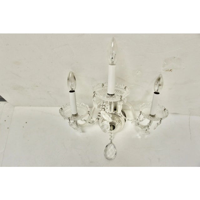 Lovely Classic, Traditional-style three-arm wall sconce. Features crystal drops and swags with cut glass cups. Arms are...