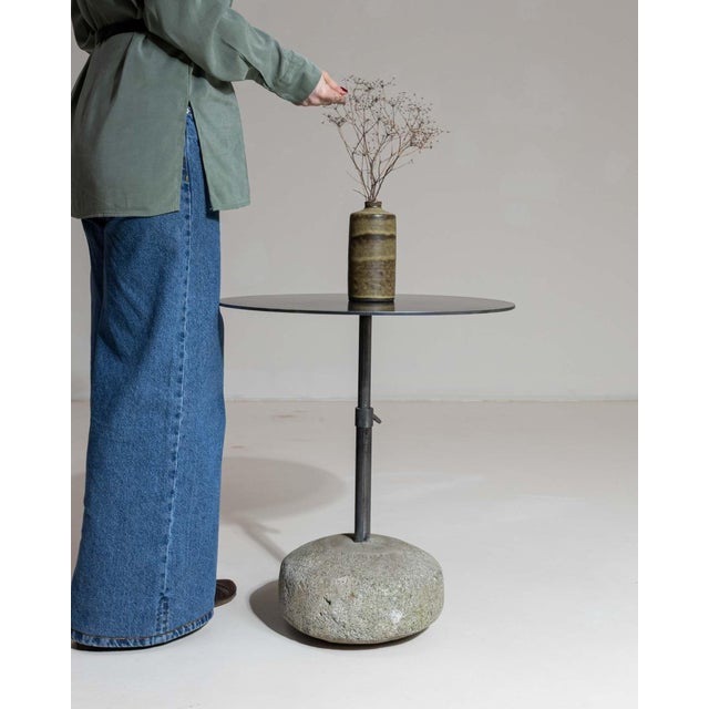 Round stone-base side table in Deep Charcoal Grey. Finished in deep charcoal grey, this round stone-base side table is...