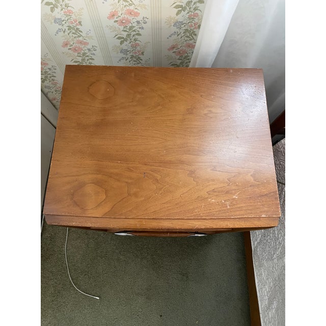 Mid-century walnut nightstand designed by T.H. Robsjohn-Gibbings for Widdicomb. Crafted in the 1950s, this piece features...