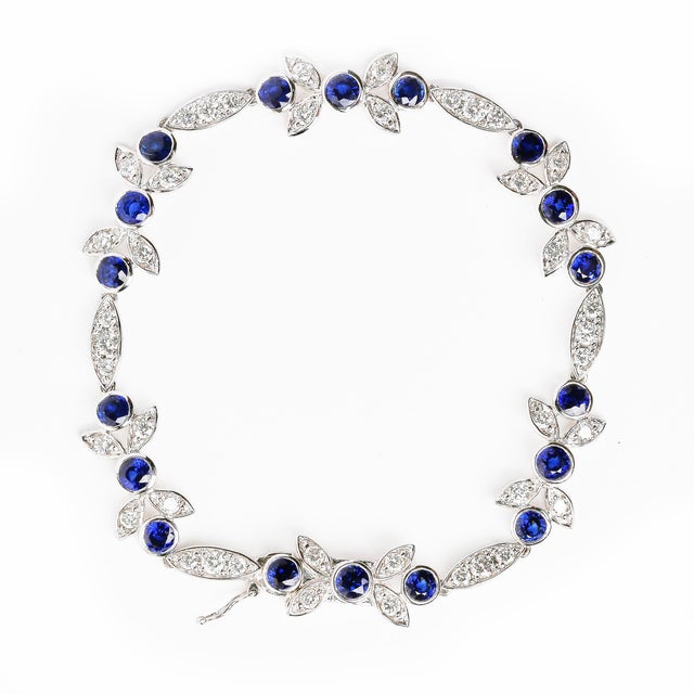 Made from a beautiful arrangement of horizontal marquise and floral shaped links, this 18k white gold bracelet graces the...