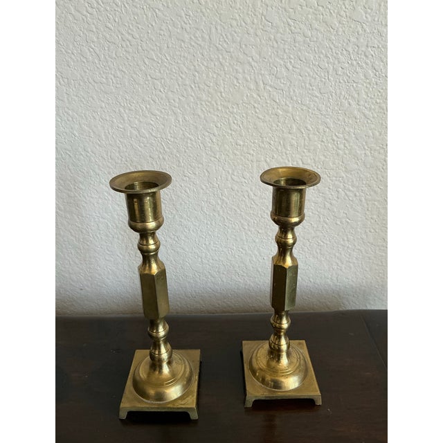 A refined pair of vintage Japanese brass candlesticks showcasing clean architectural lines and understated elegance....