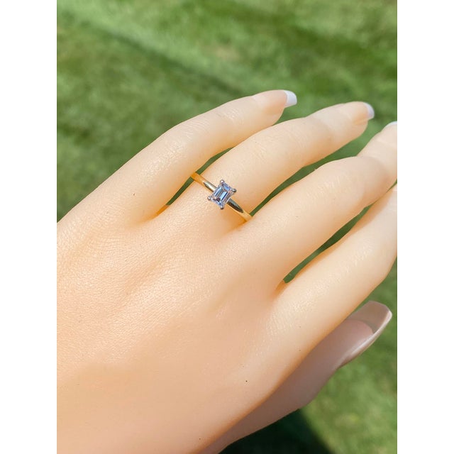 The Penn Drive: Solitaire Engagement Ring with Natural Emerald Cut Diamond. The ring features a central 0.58 carat emerald...