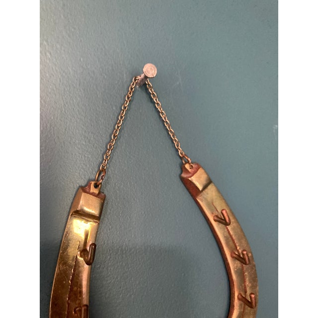 This vintage brass horseshoe wall hook by Fritz Brass brings both function and charm. Complete with a hanging chain and a...