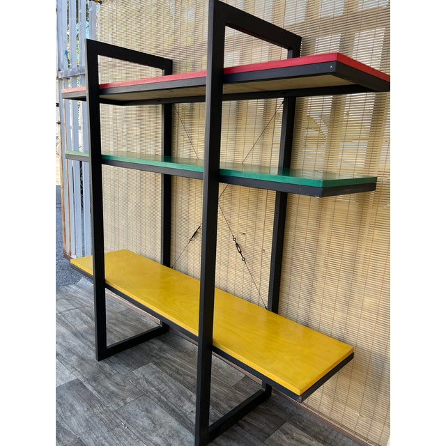 Vintage Mid Century Modern Metal Bookcase / Shelves in the Adrian Dekker for Tomado Style. C 1970s Features a black metal...