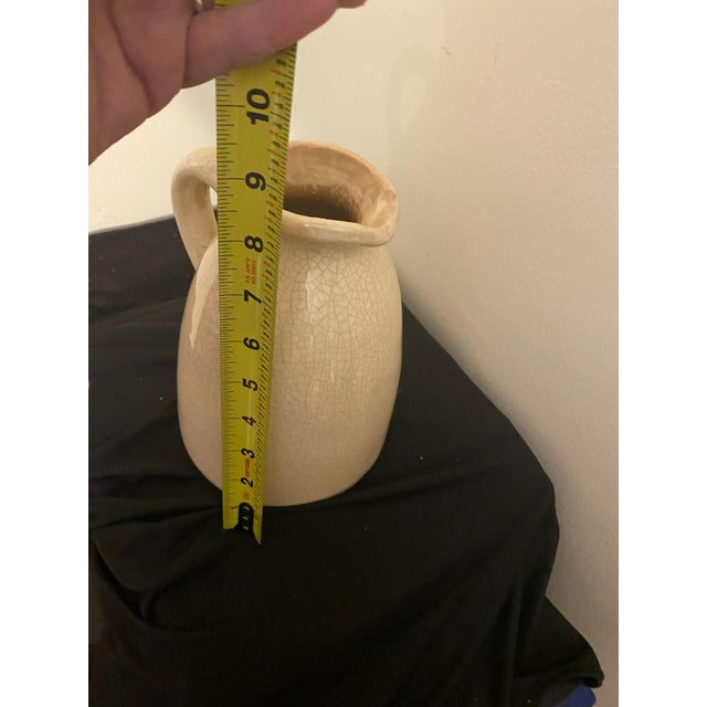 Add instant texture and rustic charm to your shelves with this beautiful vintage stoneware jug. Featuring a creamy off-...