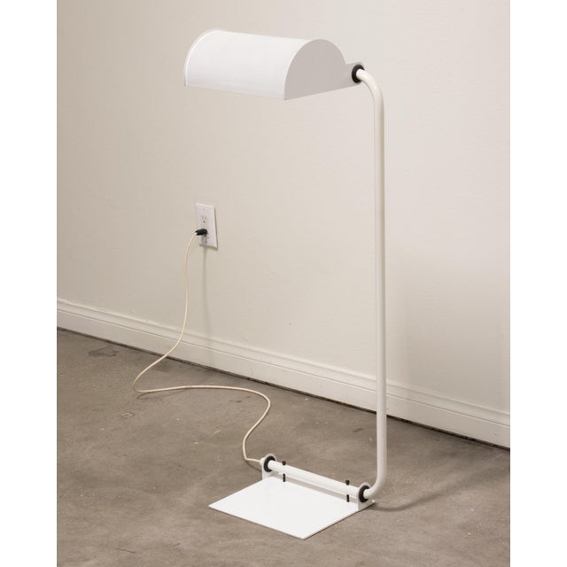 Here is a very cool vintage floor lamp by Ron Rezek. 1980s / Postmodern style with perforated shade, adjustable position...