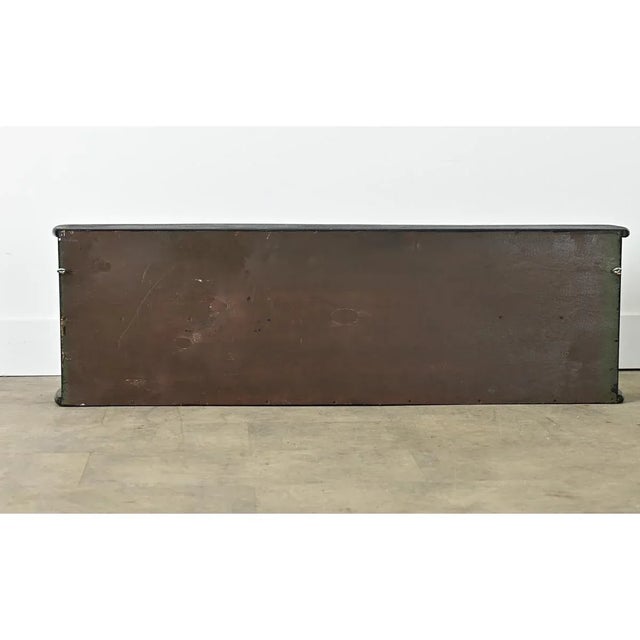 Dimensions: 15 ⅝” H x 51 ¼” W x 9 ½” D This vintage 20th century English wall-hanging cabinet was given an artistic update...