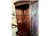 Unique single-door mahogany corner cabinet circa 1940. Features leaded class upper cabinet door and lower cabinet with...