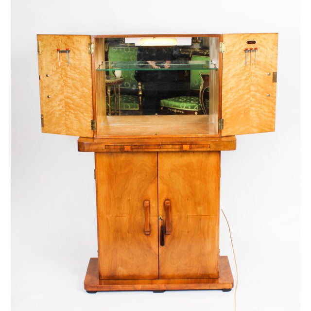 This is a fantastic antique Art Deco petite burr walnut cocktail cabinet in the Epstein manner by Turnidge of London,...