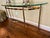 Beautiful French Regency style polished brass and glass console table by LaBarge. Lovely curves and details including...