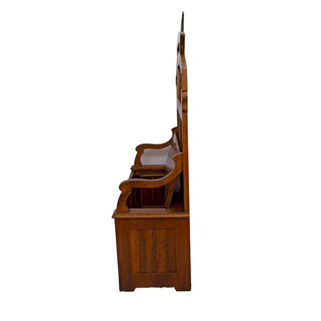 Art Nouveau chest, with a curved carved backrest and openwork scrollwork, a carved cylindrical top, a seat that lifts to...