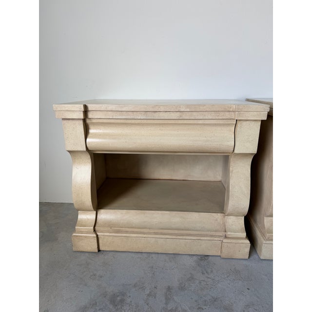 Elegant pair of vintage Ralph Lauren nightstands crafted in a refined neoclassical style. Featuring a warm cream-toned,...